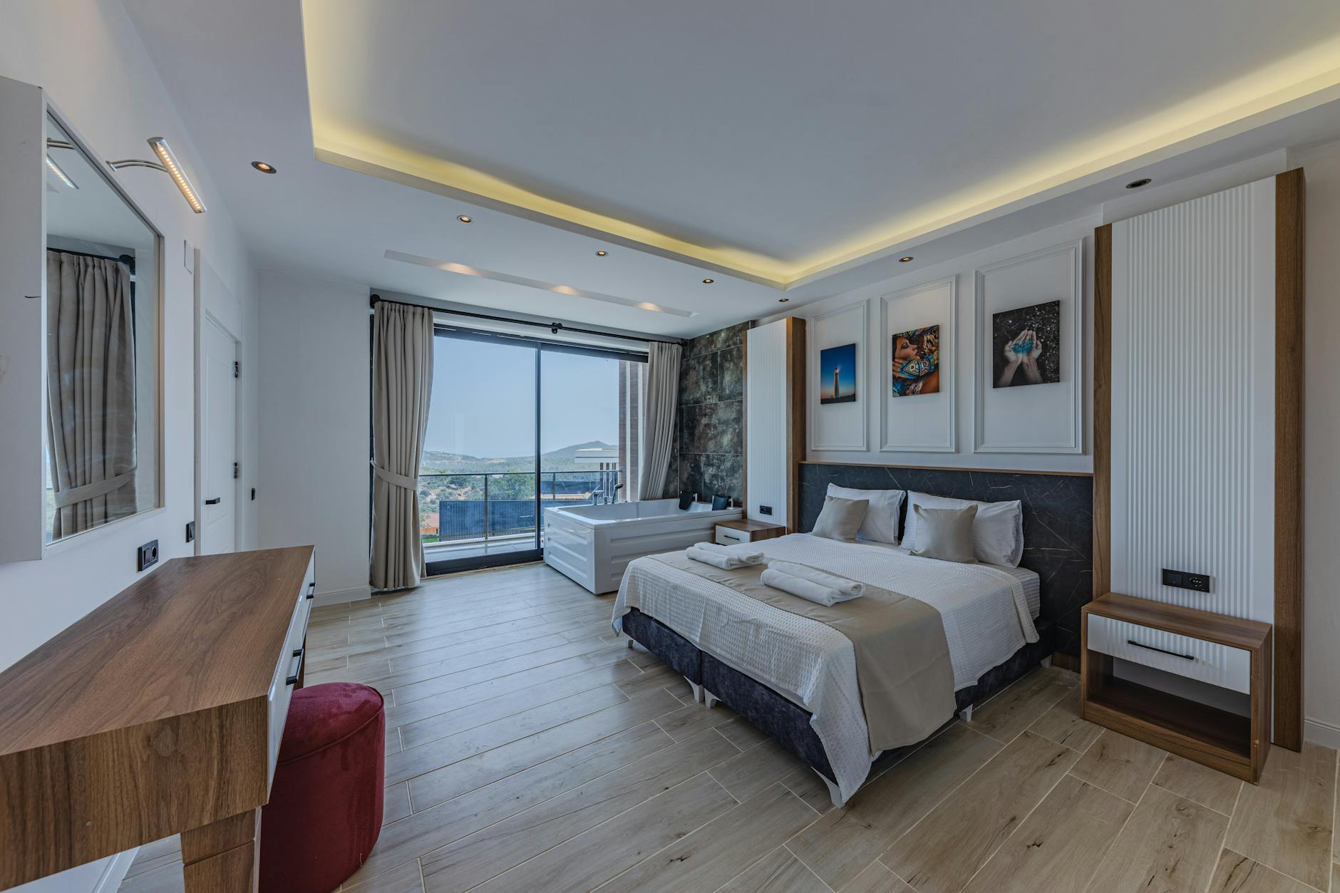 Modern lodge bedroom with private hot tub and scenic balcony view